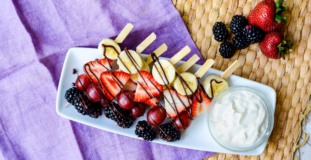 image of fruit skewers with chocolate drizzle